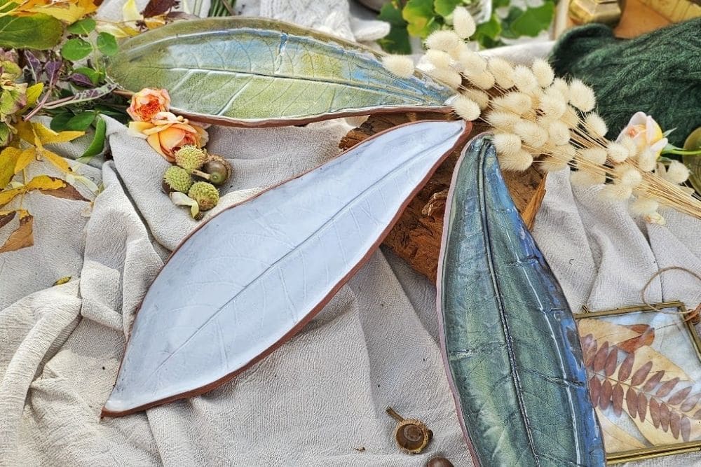 A Whistle and Page leaf-shaped handmade ceramic dishes styled on linen